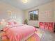 Bright bedroom with pink decor, cozy bedding, and a window overlooking lush greenery at 753 N 700 E, Franklin, IN 46131