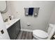 Clean bathroom with gray vanity, white toilet, and decorative towels at 8021 E 20Th St, Indianapolis, IN 46219
