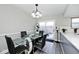 Bright dining area with glass table, black chairs, and access to a patio at 8021 E 20Th St, Indianapolis, IN 46219