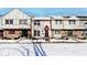 Snow covered townhouses with red awnings and brick fronts at 8021 E 20Th St, Indianapolis, IN 46219