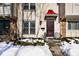 Front entrance of townhouse with red awning and black metal door at 8021 E 20Th St, Indianapolis, IN 46219