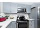 Updated kitchen featuring gray cabinets, stainless steel appliances, and white subway tile at 8021 E 20Th St, Indianapolis, IN 46219