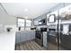 Modern gray kitchen with stainless steel appliances and white backsplash at 8021 E 20Th St, Indianapolis, IN 46219