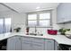 Kitchen with white quartz countertops, gray cabinets, and double sink at 8021 E 20Th St, Indianapolis, IN 46219