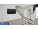 Living room with gray walls, flat screen TV, and stairs leading upstairs at 8021 E 20Th St, Indianapolis, IN 46219
