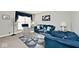 Living area with blue sofas, decorative tree, and ample natural light at 8021 E 20Th St, Indianapolis, IN 46219