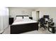 Spacious main bedroom with a king-size bed, workspace, and ample closet space at 8021 E 20Th St, Indianapolis, IN 46219