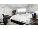 Main bedroom with king-size bed, a separate sitting area, and large windows at 8021 E 20Th St, Indianapolis, IN 46219