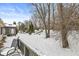 Snowy backyard view with trees and deck at 8139 River Bay E Dr, Indianapolis, IN 46240