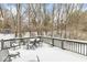 Deck with table and chairs, overlooking a snowy backyard at 8139 River Bay E Dr, Indianapolis, IN 46240