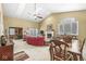 Open living room with vaulted ceiling, fireplace, and red couch at 8139 River Bay E Dr, Indianapolis, IN 46240