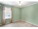 Light green bedroom with window, neutral carpet, and closet at 10361 Cerulean Dr, Noblesville, IN 46060