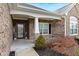 Inviting front porch with brick columns and landscaping at 1040 Forest Glen Dr, Greenfield, IN 46140