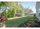 Spacious backyard with lush green grass, mature trees, and cozy seating area for relaxing outdoors at 10406 Corning Way, Fishers, IN 46038