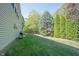 Large backyard showcasing mature trees, green lawn, and ample space for outdoor activities and relaxation at 10406 Corning Way, Fishers, IN 46038