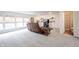Spacious basement featuring a comfortable recliner, decorative shelves and adjacent bathroom at 10406 Corning Way, Fishers, IN 46038