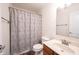 Cozy bathroom featuring a toilet, shower, and vanity with wooden cabinets at 10406 Corning Way, Fishers, IN 46038