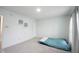 Neutral bedroom with pale blue walls, soft gray carpet, and a twin bed at 10406 Corning Way, Fishers, IN 46038