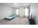 Bedroom with pale blue walls, neutral curtains, and soft gray carpet at 10406 Corning Way, Fishers, IN 46038