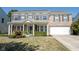 Beautiful two-story home with brick facade, attached garage, and a welcoming front porch with manicured landscaping at 10406 Corning Way, Fishers, IN 46038