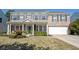 Two-story brick home with a welcoming front porch and attached two car garage at 10406 Corning Way, Fishers, IN 46038