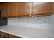 Close-up shot of a kitchen counter featuring a white subway tile backsplash and crisp white countertops at 10406 Corning Way, Fishers, IN 46038