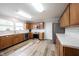 Well-lit kitchen features wooden cabinets, stainless steel appliances, and modern subway tile backsplash at 10406 Corning Way, Fishers, IN 46038
