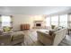 Cozy living room with a stone fireplace, neutral tones, and plenty of seating at 10406 Corning Way, Fishers, IN 46038