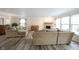 Inviting living room with fireplace, natural light, and wood-style flooring at 10406 Corning Way, Fishers, IN 46038