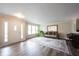 Bright living room featuring wood-look floors, a large mirror, and comfortable seating at 10406 Corning Way, Fishers, IN 46038