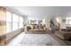 Bright living room showcasing ample natural light, wood flooring, and an open layout at 10406 Corning Way, Fishers, IN 46038