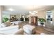 Open-plan living room with hardwood flooring, neutral paint colors, and plenty of space at 10406 Corning Way, Fishers, IN 46038