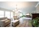 Open living space boasting hardwood floors, neutral paint, and lots of natural light at 10406 Corning Way, Fishers, IN 46038