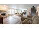 Spacious living room featuring a stone fireplace, large windows, and neutral decor at 10406 Corning Way, Fishers, IN 46038