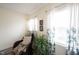 Comfortable sitting area with a wicker chair, throw blanket, and bright windows at 10406 Corning Way, Fishers, IN 46038