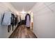 Spacious walk-in closet with wood look flooring, white wire shelving, and storage space at 10406 Corning Way, Fishers, IN 46038