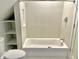 Clean bathroom, featuring a bathtub, toilet and shelving at 114 N Oriental St, Indianapolis, IN 46202