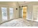 Bedroom with double doors to balcony and barn door closet at 114 N Oriental St, Indianapolis, IN 46202
