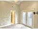 Bedroom with double doors to balcony and ensuite bathroom at 114 N Oriental St, Indianapolis, IN 46202