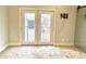 Bedroom featuring double doors opening to a private balcony at 114 N Oriental St, Indianapolis, IN 46202