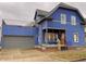 Stunning blue two-story home with gray accents, a detached garage, and a deck at 114 N Oriental St, Indianapolis, IN 46202