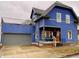 Stunning blue two-story home with gray accents, a detached garage, and a deck at 114 N Oriental St, Indianapolis, IN 46202