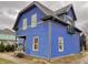 Side view of a charming blue house with gray accents and a small balcony at 114 N Oriental St, Indianapolis, IN 46202