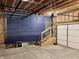 Unfinished garage with overhead storage and stairs at 114 N Oriental St, Indianapolis, IN 46202