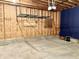 Unfinished garage with overhead storage and stairs at 114 N Oriental St, Indianapolis, IN 46202
