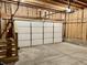 Unfinished garage with overhead storage and stairs at 114 N Oriental St, Indianapolis, IN 46202