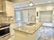 Modern kitchen with granite island and stainless steel appliances at 114 N Oriental St, Indianapolis, IN 46202