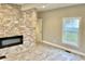 Living room featuring a contemporary fireplace and gray wood-look tile floors at 114 N Oriental St, Indianapolis, IN 46202