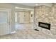 Open concept living area with a stone fireplace and gray tile flooring at 114 N Oriental St, Indianapolis, IN 46202