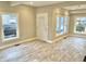 Bright living room with large windows and gray tile floors at 114 N Oriental St, Indianapolis, IN 46202